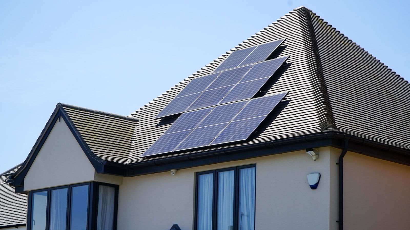Solar PV panels installed on the tiled roof of a detached home